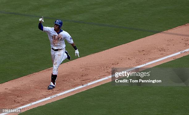 Carlos Gomez of the Texas Rangers celebrates after hitting a grand slam against Felix Hernandez of the Seattle Mariners in the bottm of the fourth...