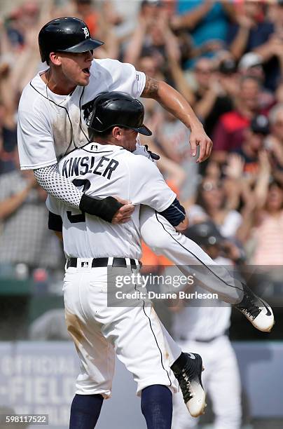 JaCoby Jones of the Detroit Tigers jumps into the arms of Ian Kinsler of the Detroit Tigers after scoring the winning run against the Chicago White...