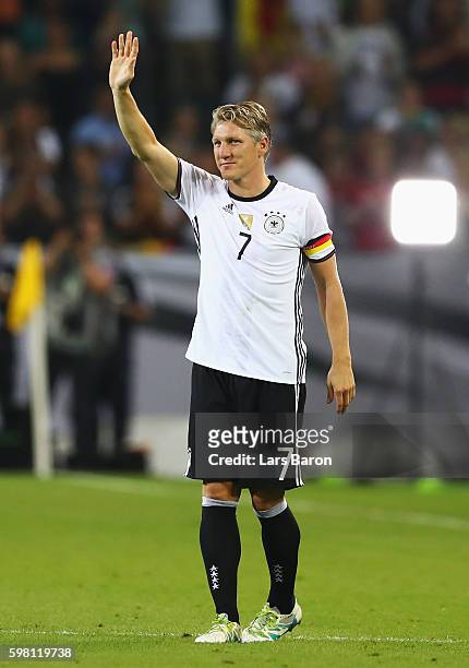 Bastian Schweinsteiger of Germany acknowledges the crowd after his last international match during the International Friendly match between Germany...