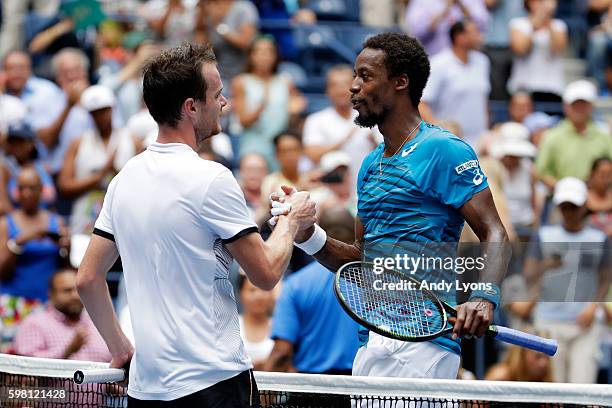 Gael Monfils of France shakes hands with Jan Satral of the Czech Republic after their second round Men's Singles match on Day Three of the 2016 US...