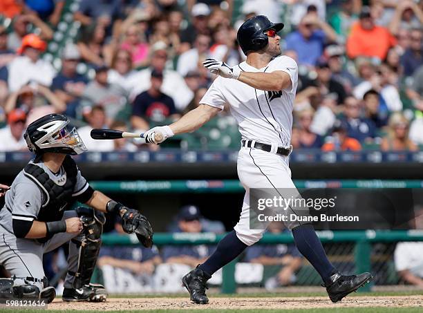 Tyler Collins of the Detroit Tigers watches his game-winning sacrifice fly ball while catcher Alex Avila of the Chicago White Sox looks on at...