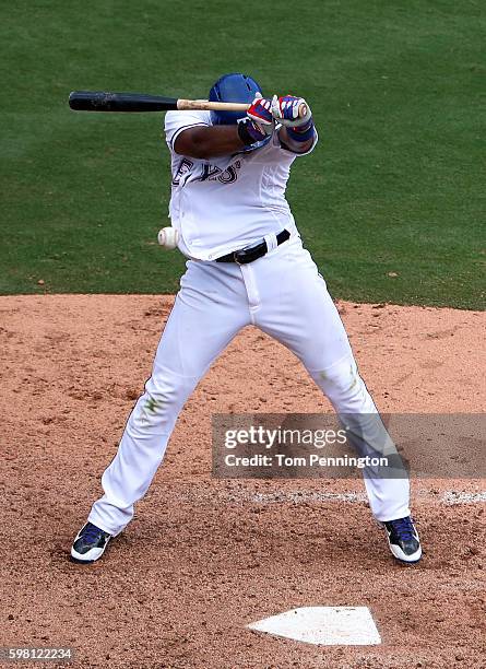 Elvis Andrus of the Texas Rangers is hit by a pitch from Arquimedes Caminero of the Seattle Mariners in the bottom of the seventh inning at Globe...