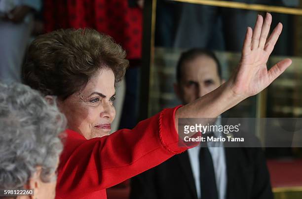 Impeached President Dilma Rousseff waves to the crowd before delivering her farewell address in Alvorado Palace on August 31, 2016 in Brasilia,...