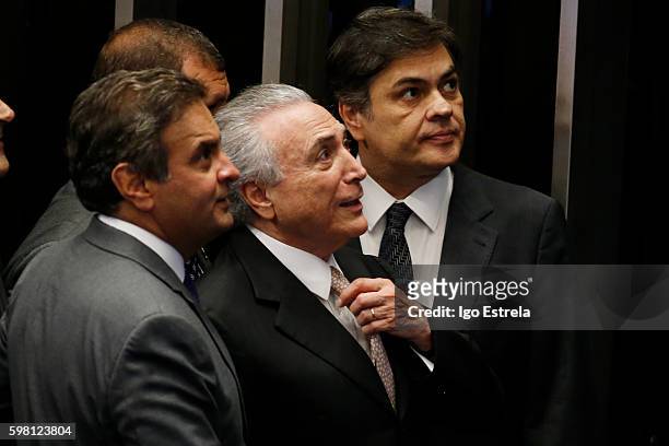 Michel Temer, Senator Aécio Neves and Senator Cássio Cunha Lima look on as Temer is sworn in as Interim President following the impeachment of...