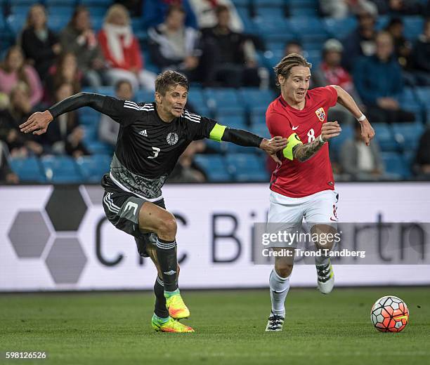 Stefan Johansen of Norway and Aleksandr Myrtynovich of Belarus during the match between Norway and Belarus at Ullevaal Stadion on August 31, 2016 in...