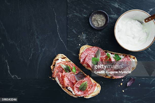 white bean, horseradish and salami bruschetta - salami stock pictures, royalty-free photos & images