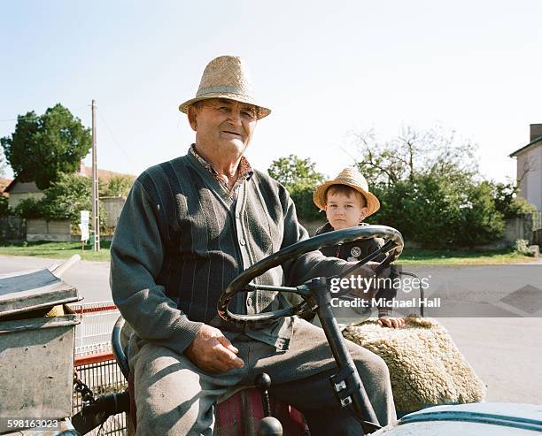 grandfather and grandson on tractor - portrait solid stock pictures, royalty-free photos & images