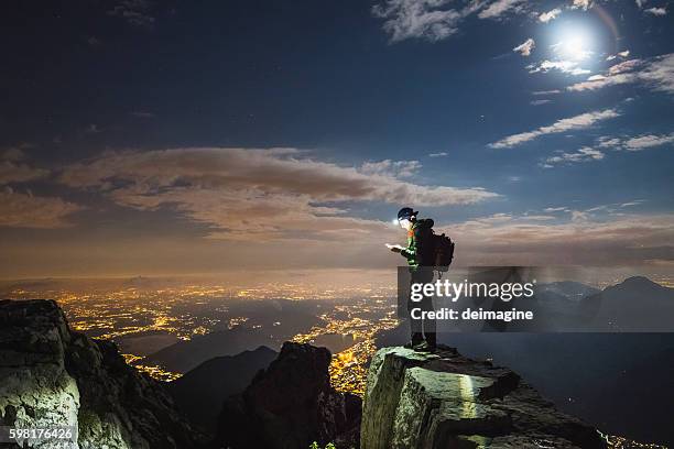 hiker checks your device on top on the mount - tech summit stock pictures, royalty-free photos & images