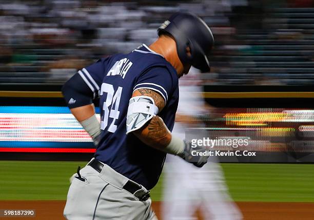 Oswaldo Arcia of the San Diego Padres heads home after hitting a solo homer in the fourth inning against the Atlanta Braves at Turner Field on August...