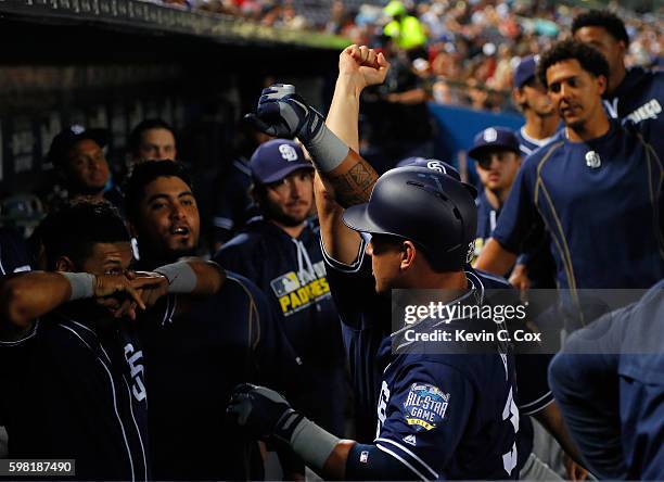 Oswaldo Arcia of the San Diego Padres reacts in the dugout after hitting a solo homer in the fourth inning against the Atlanta Braves at Turner Field...