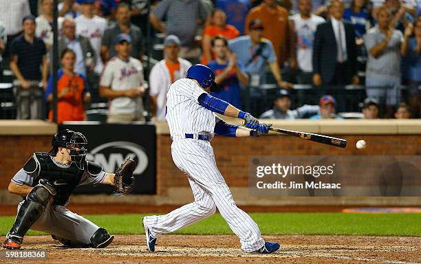 Kelly Johnson of the New York Mets connects on an eighth inning three run double against the Miami Marlins at Citi Field on August 31, 2016 in the...