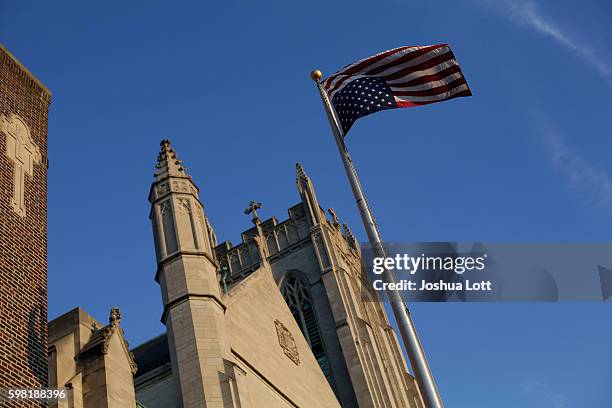 The American flag outside Father Pfleger's St. Sabina Church flies upside down on the flag pole outside of his church after protesting the recent...