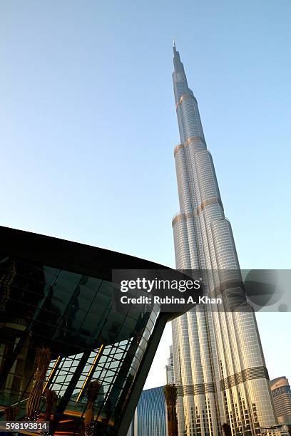 The dhow-shaped Dubai Opera on opening night dots the skyline alongside the iconic Burj Khalifa on August 31, 2016 in Dubai, United Arab Emirates.