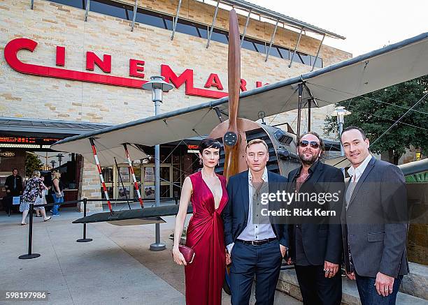 Actress Victoria Summer, actor Werner Daehn, writer/director Damien Lay, and actor Chris Klein pose next to one of the original fighter planes from...