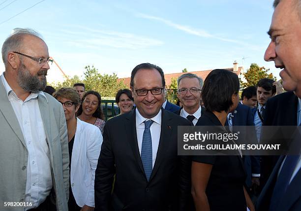 French President Francois Hollande and French Minister of Education Najat Vallaud-Belkacem arrive for a visit of the primary school Nécotin and the...