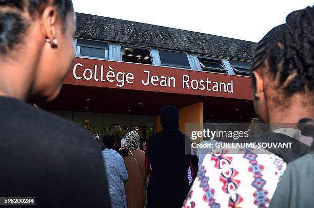 Students wait outside the high school Jean Rostand during the visit of French President and French Minister of Education for the first day of the...