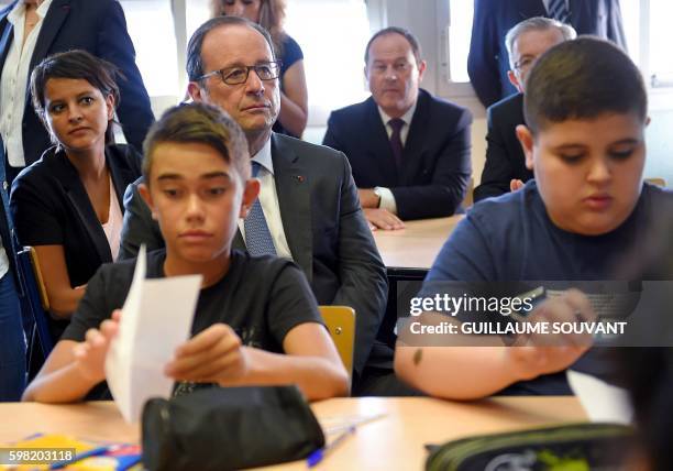 French President Francois Hollande sits with French Minister of Education Najat Vallaud-Belkacem in a classroom during a visit at the high school...