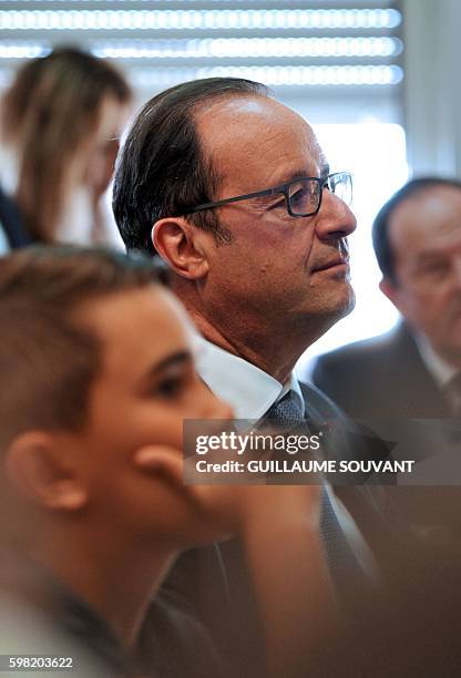 French President Francois Hollande looks on during a visit at the high school Jean Rostand for the first day of the starting of the school year in...