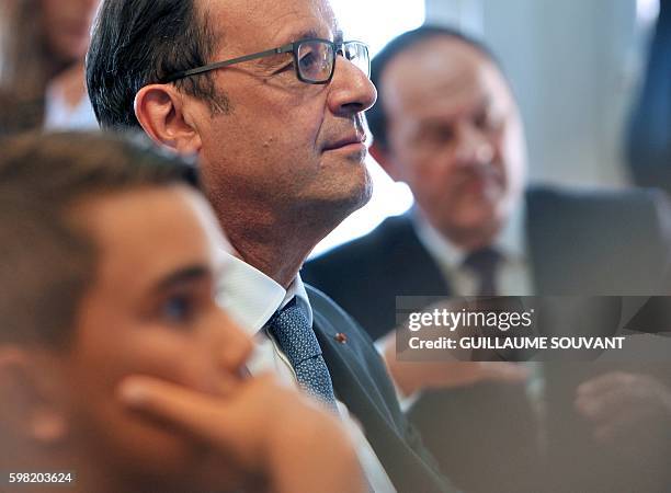 French President Francois Hollande looks on during a visit at the high school Jean Rostand for the first day of the starting of the school year in...