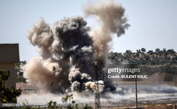 This picture taken on September 1, 2016 in the Turkish-Syrian border town of Karkamis, in the southern region of Gaziantep, shows smoke rising close...