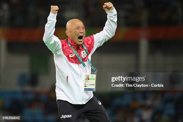 Day 12 Japanese coach Kazuhito Sakae celebrates the dramatic last second victory of Eri Tosaka of Japan against Mariya Stadnik of Azerbaijan during...