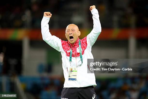 Day 12 Japanese coach Kazuhito Sakae celebrates the dramatic last second victory of Eri Tosaka of Japan against Mariya Stadnik of Azerbaijan during...