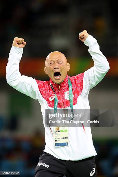 Day 12 Japanese coach Kazuhito Sakae celebrates the dramatic last second victory of Eri Tosaka of Japan against Mariya Stadnik of Azerbaijan during...