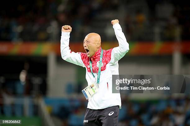 Day 12 Japanese coach Kazuhito Sakae celebrates the dramatic last second victory of Eri Tosaka of Japan against Mariya Stadnik of Azerbaijan during...