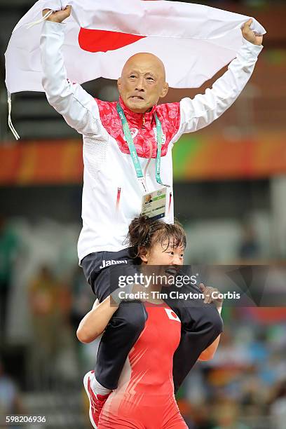 Day 12 Eri Tosaka of Japan celebrates her dramatic last minute victory against Mariya Stadnik of Azerbaijan carrying coach Kazuhito Sakae around the...