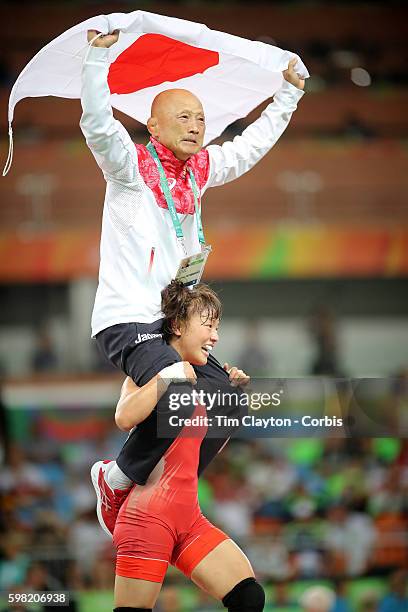 Day 12 Eri Tosaka of Japan celebrates her dramatic last minute victory against Mariya Stadnik of Azerbaijan carrying coach Kazuhito Sakae around the...