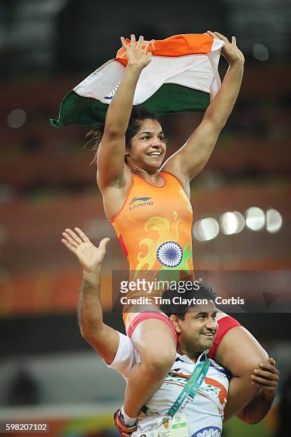 Day 12 Sakshi Malik of India celebrates victory against Aisuluu Tynybekova of Kyrgyzstan during their Women's Freestyle 58 kg Bronze Medal Final at...