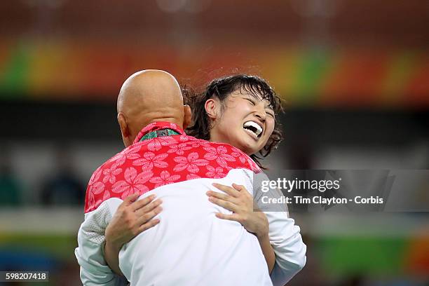 Day 12 Sara Dosho of Japan celebrates victory with coach Kazuhito Sakae over Natalia Vorobeva of Russia during their Women's Freestyle 69 kg Gold...