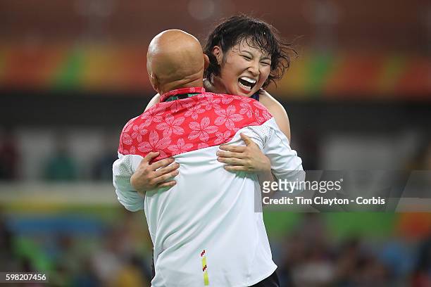 Day 12 Sara Dosho of Japan celebrates victory with coach Kazuhito Sakae over Natalia Vorobeva of Russia during their Women's Freestyle 69 kg Gold...