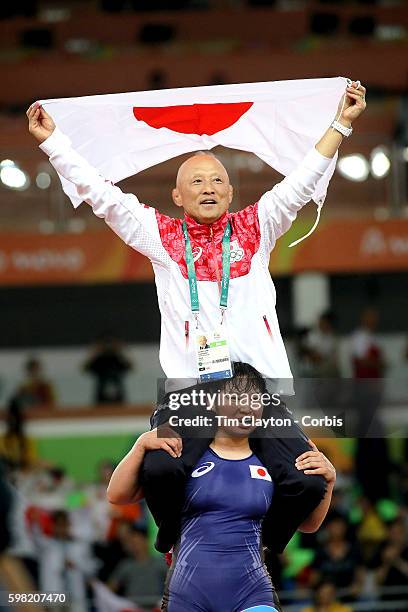 Day 12 Sara Dosho of Japan celebrates victory with coach Kazuhito Sakae over Natalia Vorobeva of Russia during their Women's Freestyle 69 kg Gold...