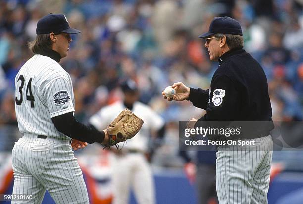 Manager Jeff Torborg of the Chicago White Sox hands the ball to new pitcher Ken Patterson during an Major League Baseball game circa 1991 at Comiskey...