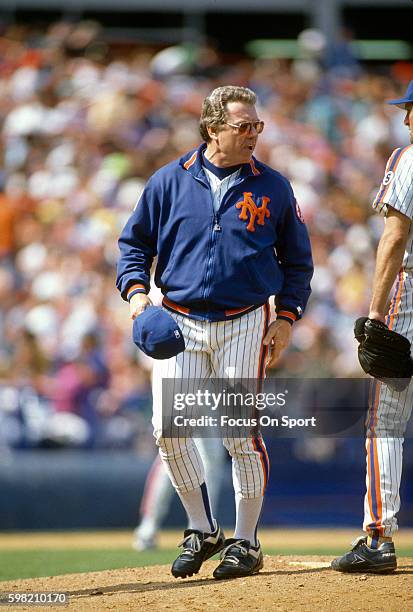 Manager Jeff Torborg of the New York Mets stands on the mound talking with his pitcher during an Major League Baseball game circa 1992 at Shea...
