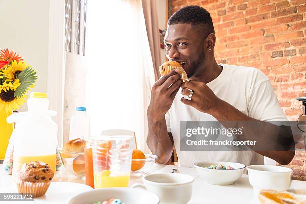 man doing the breakfast at home with muffin - continental breakfast stock pictures, royalty-free photos & images