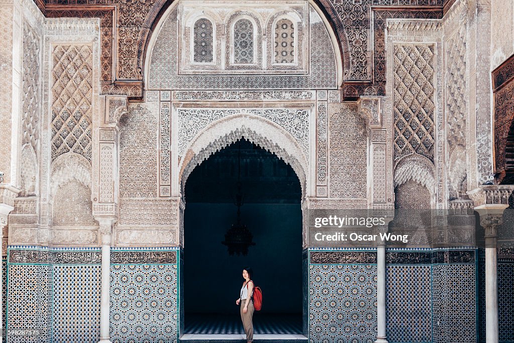 Woman tourist visiting old temple in Marrakech