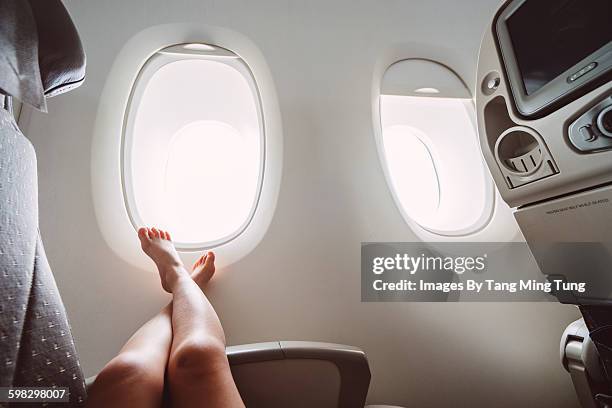 little girl relaxing in the airplane - bare foot stock pictures, royalty-free photos & images