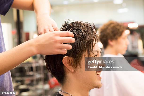 young man having hair cut - atsushi yamada stock pictures, royalty-free photos & images