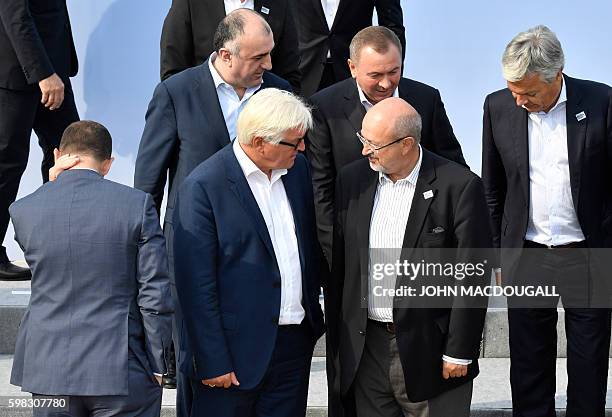German Foreign Minister Frank-Walter Steinmeier and OSCE General Secretary Lamberto Zannier chat as they pose for a group photo during the Informal...