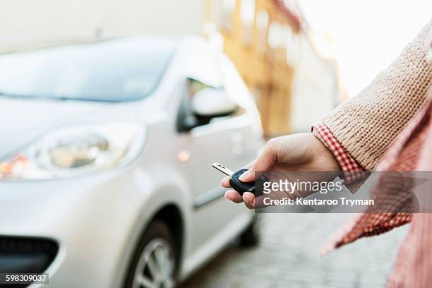 cropped image of businesswoman using remote control key to unlock car - car key 個照片及圖片檔