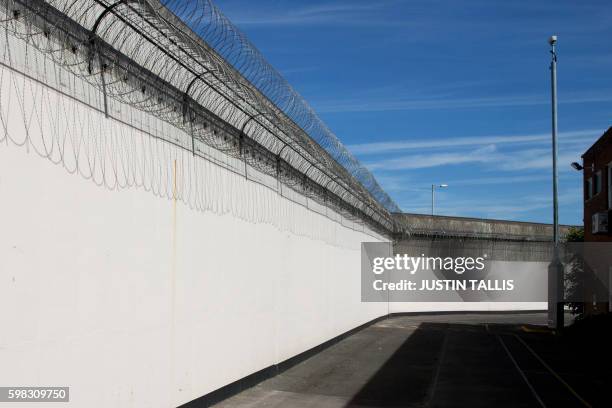 Coils of barbed wire are pictured on the walls inside Reading prison during an exhibition photocall at the prison in Reading, west of London on...