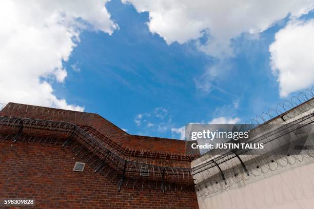 Coils of barbed wire are pictured on the walls inside Reading prison during an exhibition photocall at the prison in Reading, west of London on...