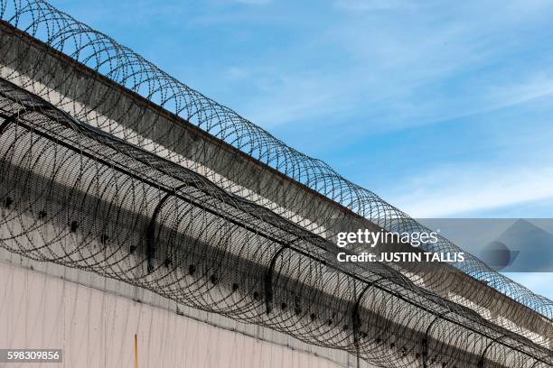 Coils of barbed wire are pictured on the walls inside Reading prison during an exhibition photocall at the prison in Reading, west of London on...