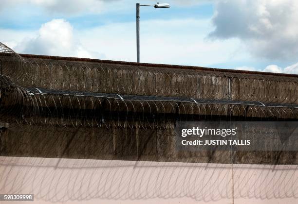 Coils of barbed wire are pictured on the walls inside Reading prison during an exhibition photocall at the prison in Reading, west of London on...