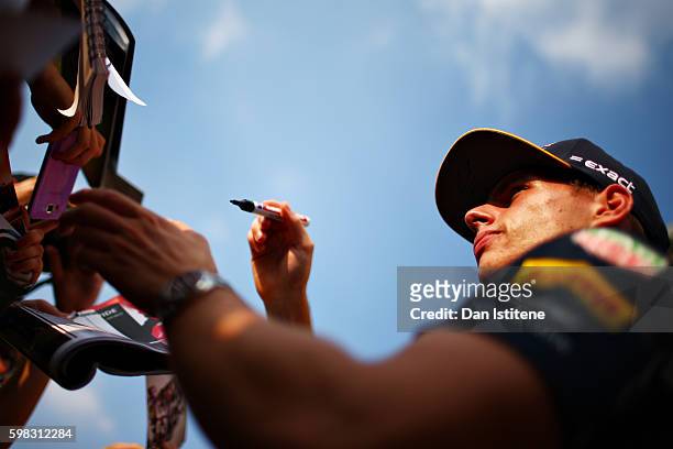 Max Verstappen of Netherlands and Red Bull Racing signs autographs for fans in the Pitlane during previews for the Formula One Grand Prix of Italy at...