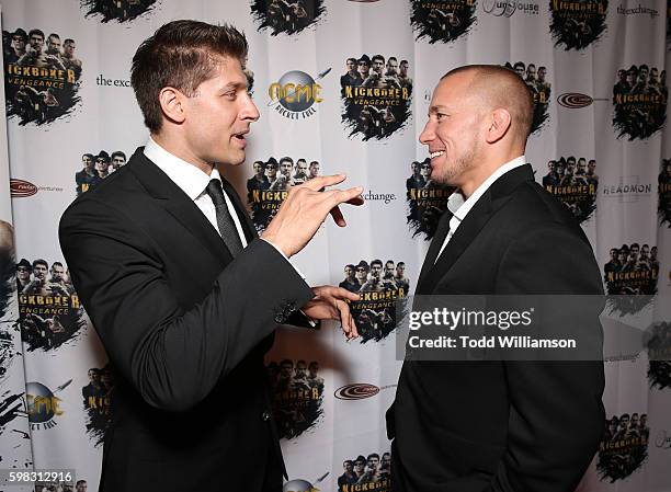 Alain Moussi and Georges St-Pierre attend the premiere Of RLJ Entertainment's "Kickboxer: Vengeance" at iPic Theaters on August 31, 2016 in Los...