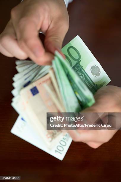 hands counting stack of cash - expense fraud stock pictures, royalty-free photos & images