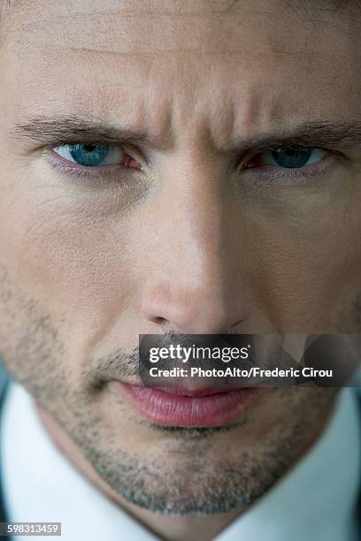 businessman glaring with furrowed brow, portrait - knitting brow stock pictures, royalty-free photos & images